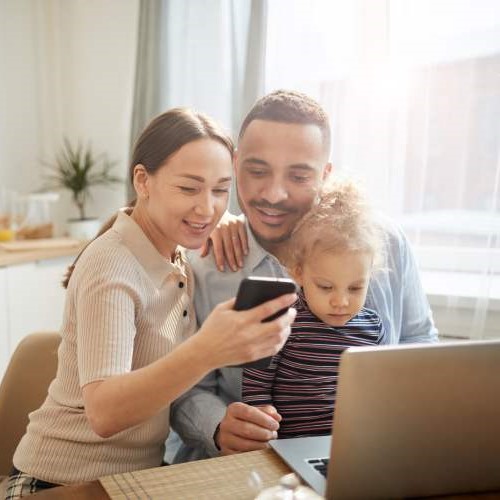 Couple and child using computer.